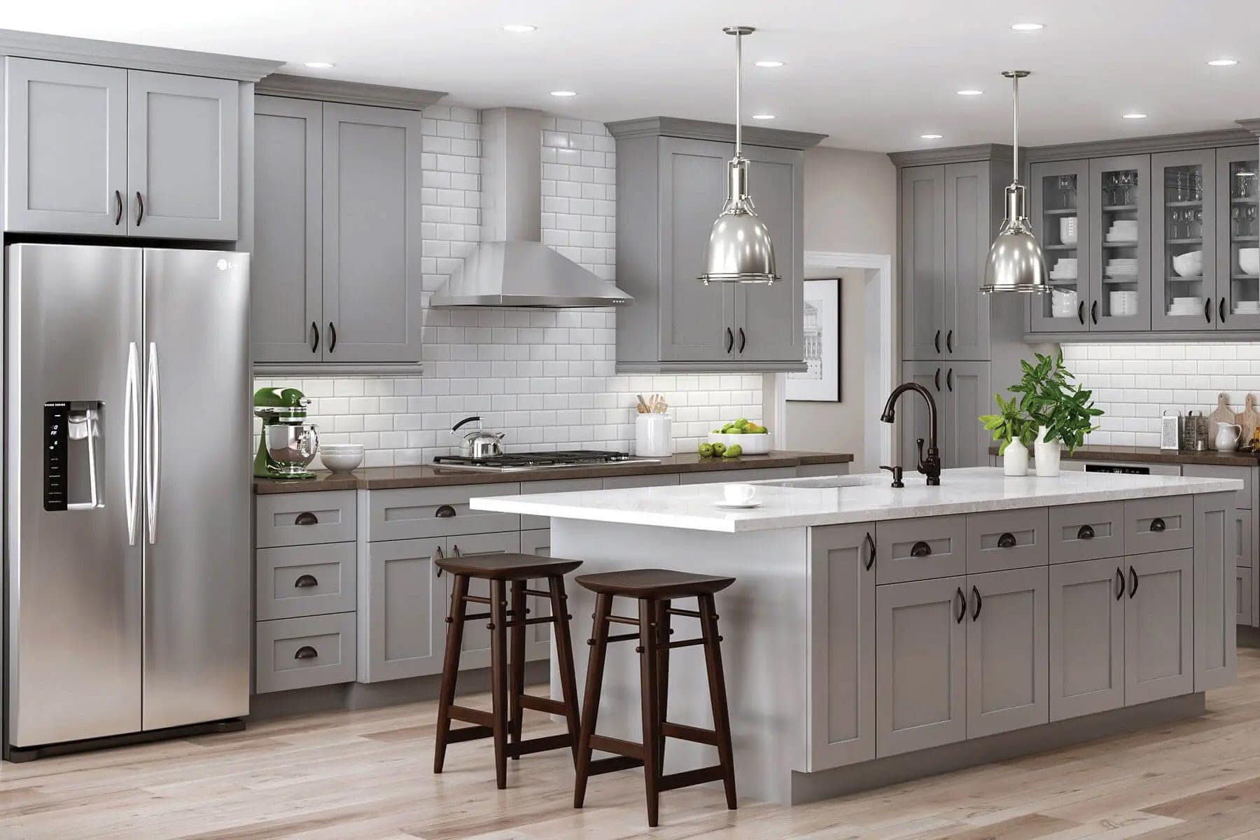 Cabinet style example — grey shaker cabinetry with a white island and subway tile