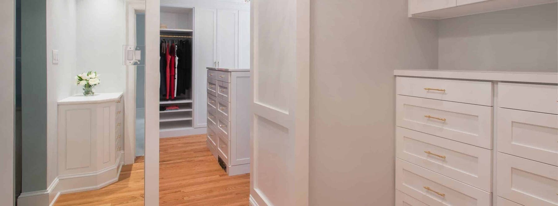 Organized-space inspiration: a walk-in closet with hanging, shelving and a central drawer unit