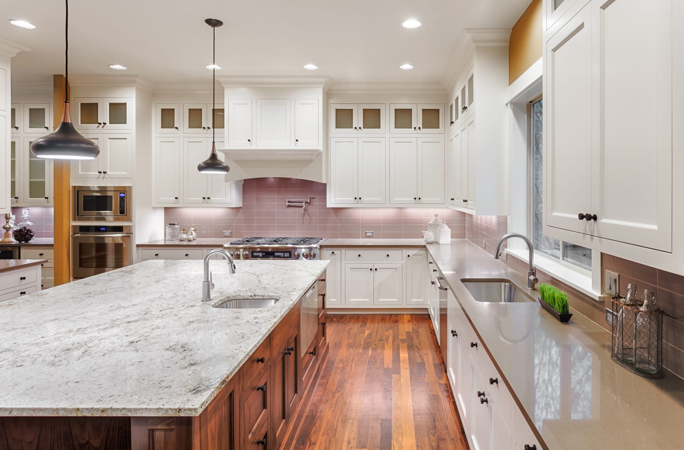 Cali Craft kitchen renovation with white cabinetry, granite countertops and hardwood flooring