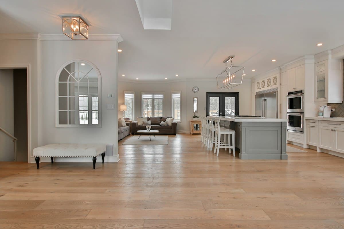 An open-plan room with pale timber flooring